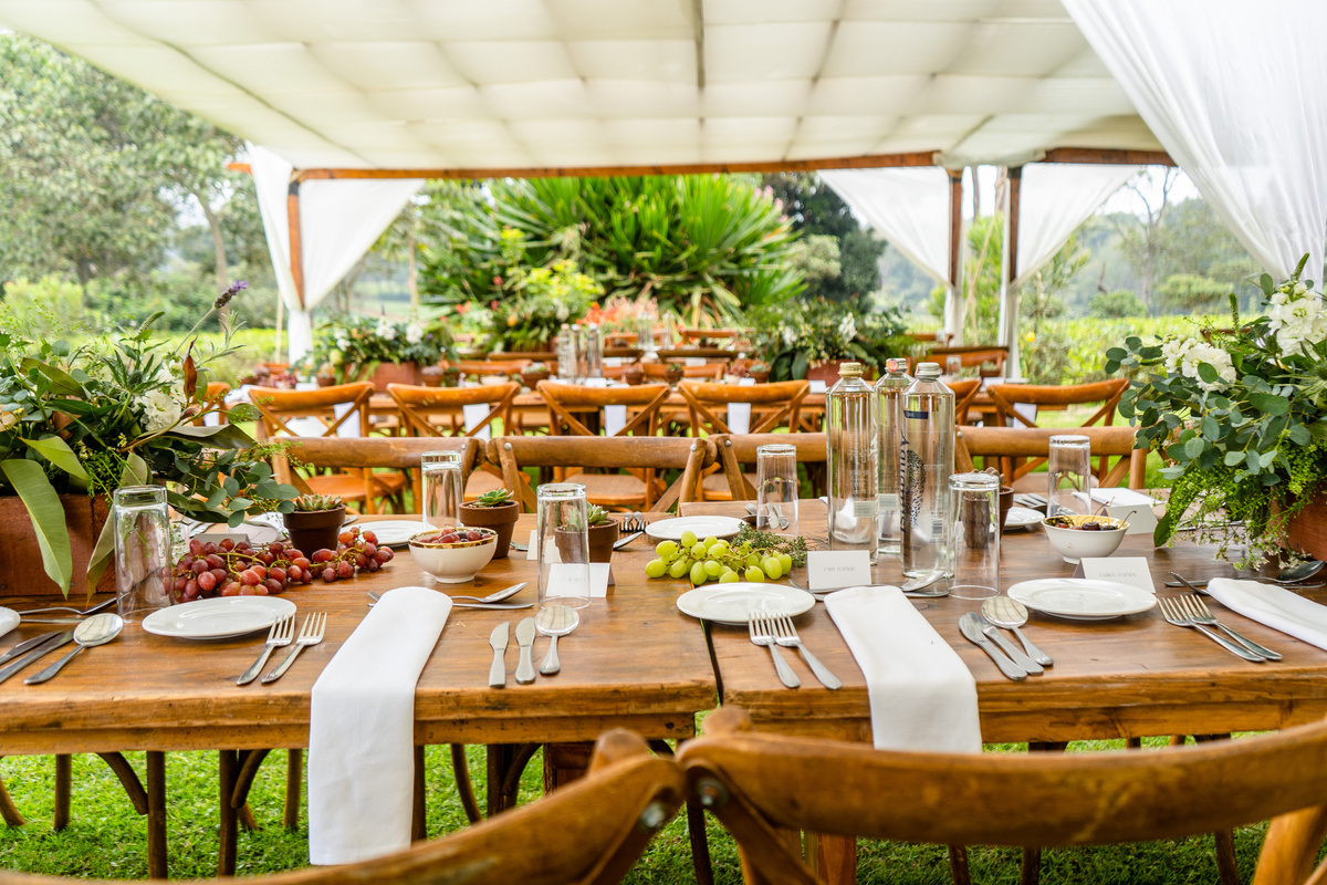 Outdoor dinner party venue with arranged wooden tables